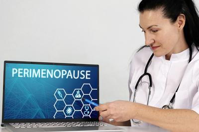 Female doctor pointing at laptop screen showing perimenopause