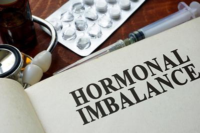 Concept image of homrmonal imbalance written on notes