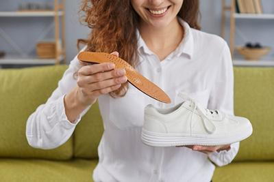 Orthopedic Shoes holding by a woman.