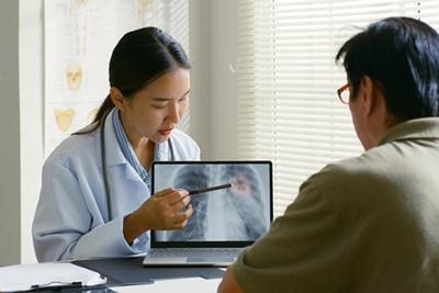 Doctor-Reviewing-Senior-Patient’s-Lung-X-ray-Results