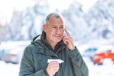 Smiling-Man-Applying-Sunscreen-to-His-Cheeks