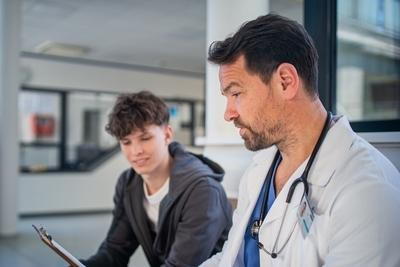 Adolescent boy having a consultation with the doctor on clinic