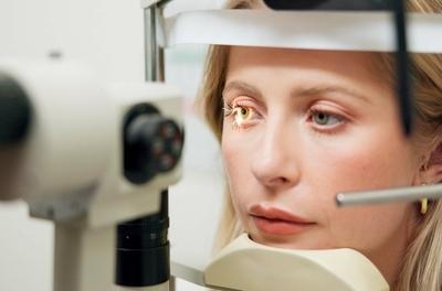 Woman-wearing-trial-frames-at-eye-exam.