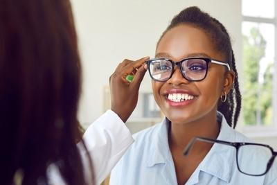 Doctor examing patient eye with different eye glasses