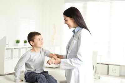 Child being examined for sports clearance by pediatrician