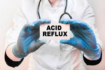 Physician explaining acid reflux diagnosis with a document in hand.