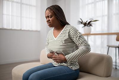 Woman with stomach ache due to abdominal discomfort