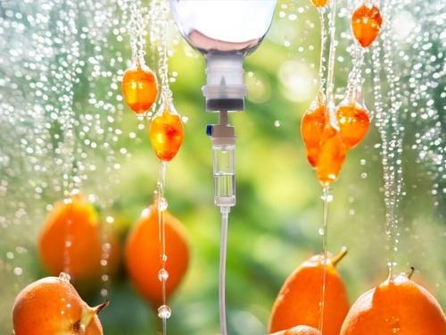 IV vitamin therapy infusion with oranges in the background