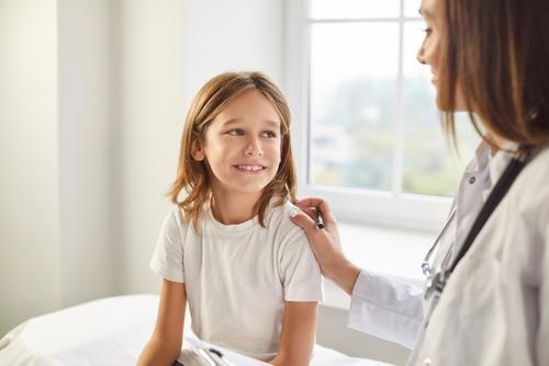 Child meeting pediatrician for routine checkup