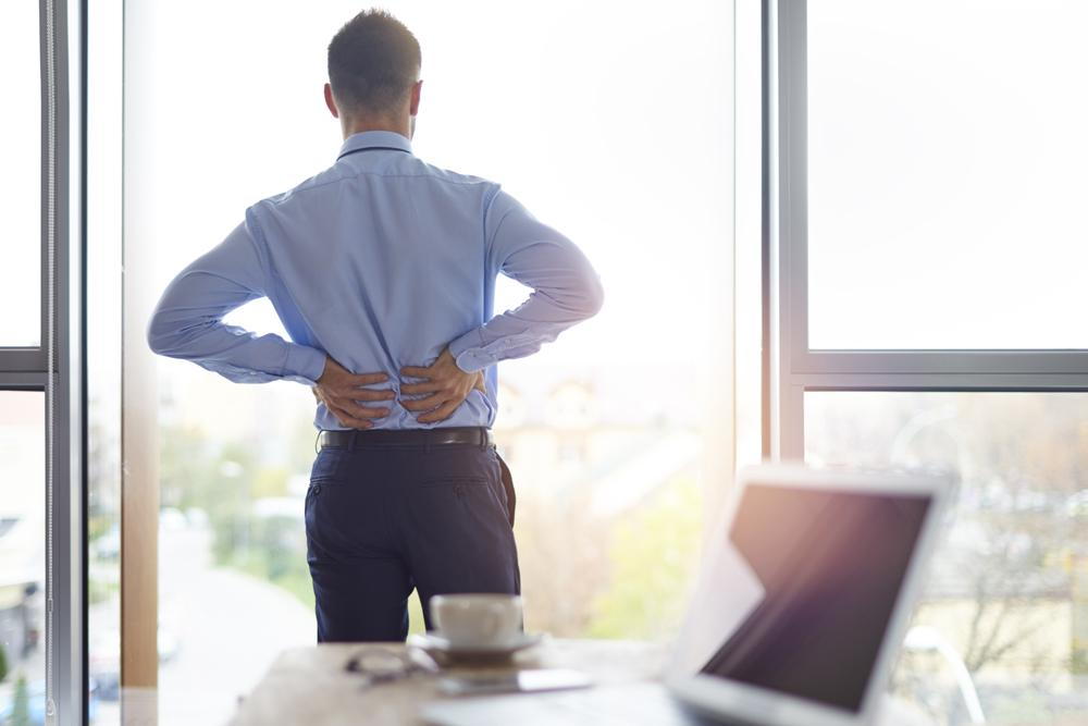 Man with back pain due to poor posture
