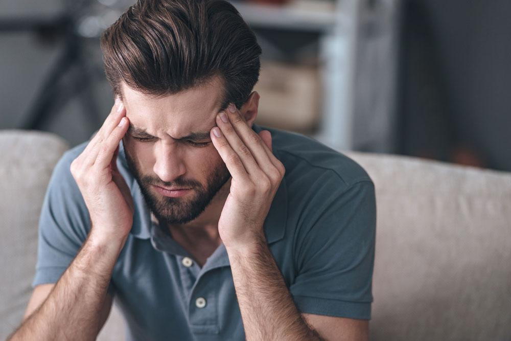 man suffering from a painful headache