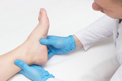 Podiatrist-Examines-Patient's-Painful-Heel