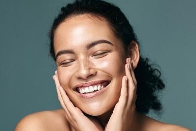 Flawless woman smiling on camera.