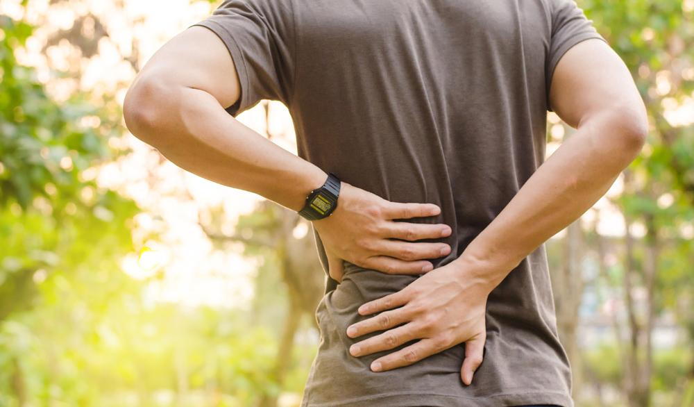 man has lower back pain in Omaha