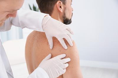 Male-Skin-Doctor-Checking-Patient's-Skin