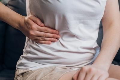 Person holding side with gallstone pain