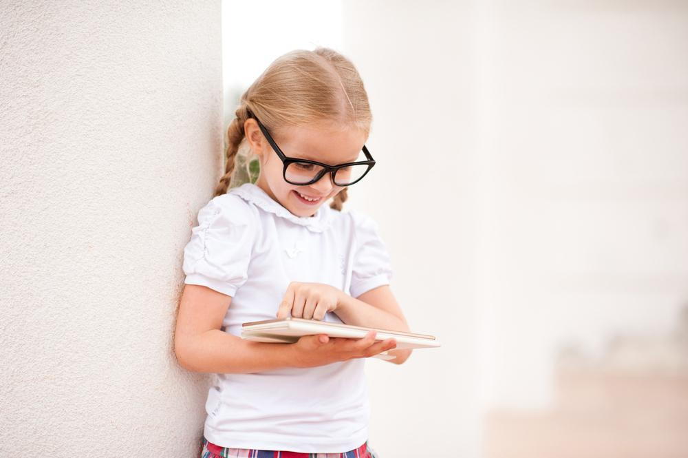 girl with glasses reading a book