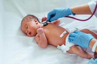 Newborn screening in the clinic with the doctor and stethoscope.