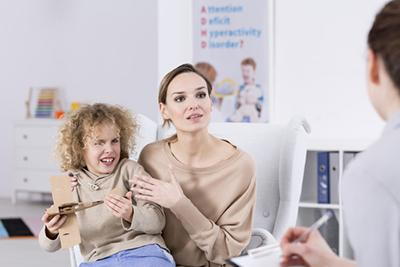 Mother with annoying child talk to a therapist
