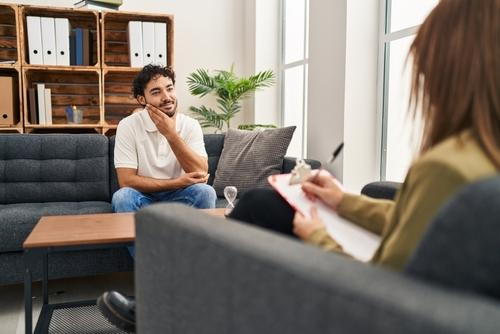 Male client participating in a one-on-one psychotherapy session with a therapist