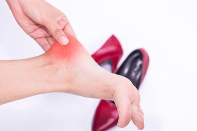 Person with heel pain with red shoes and red highlights.
