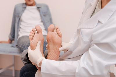 Doctor checking the foot condition of patient