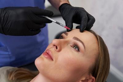 Female patient undergoing cosmetic Botox procedure