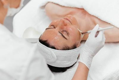 Female patient receiving chemical peel for hyperpigmentation