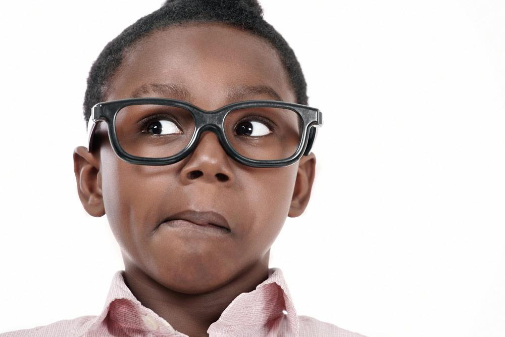 a child wearing glasses and looking up