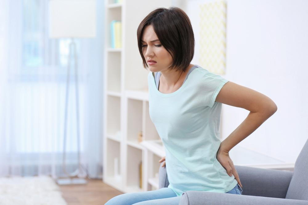 woman sitting in pain