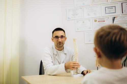 Child attending a chiropractic appointment for spinal health and wellness