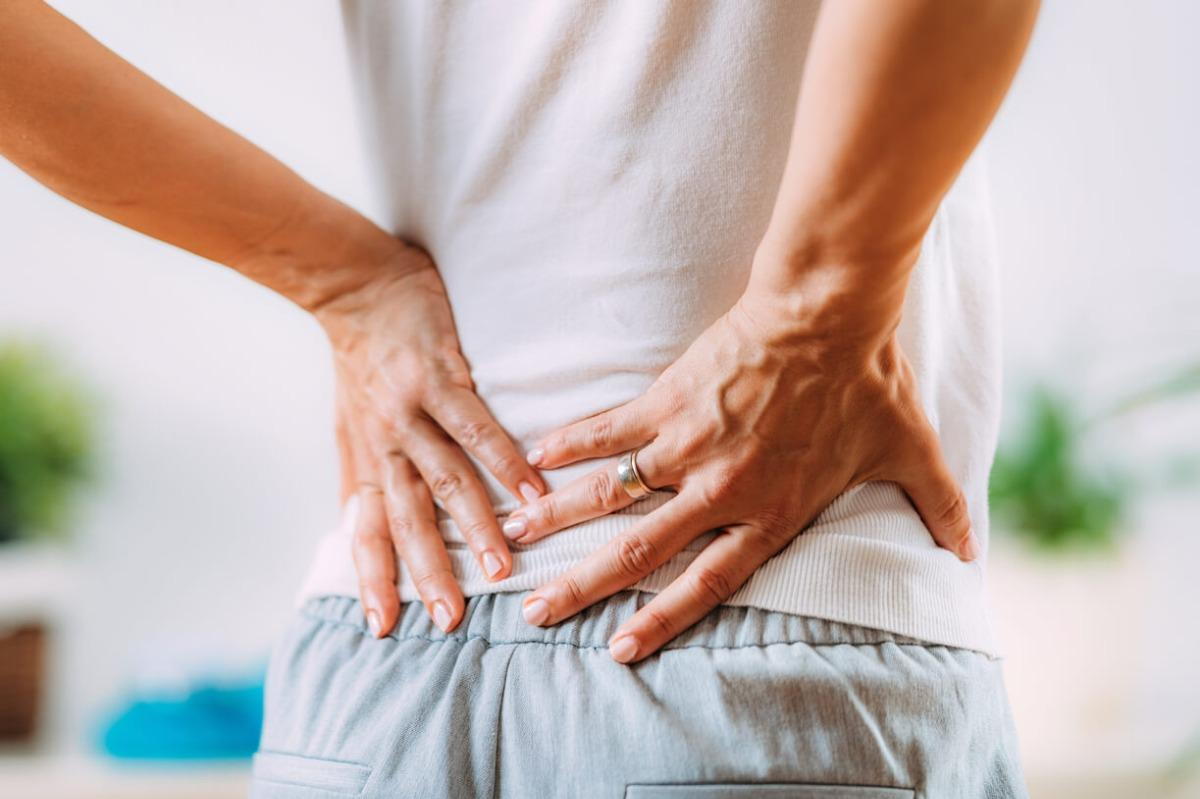 woman suffering low back pain in need of chiropractic care