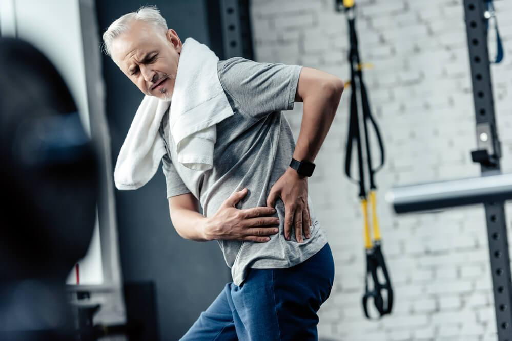 man in pain looking how to crack lower back