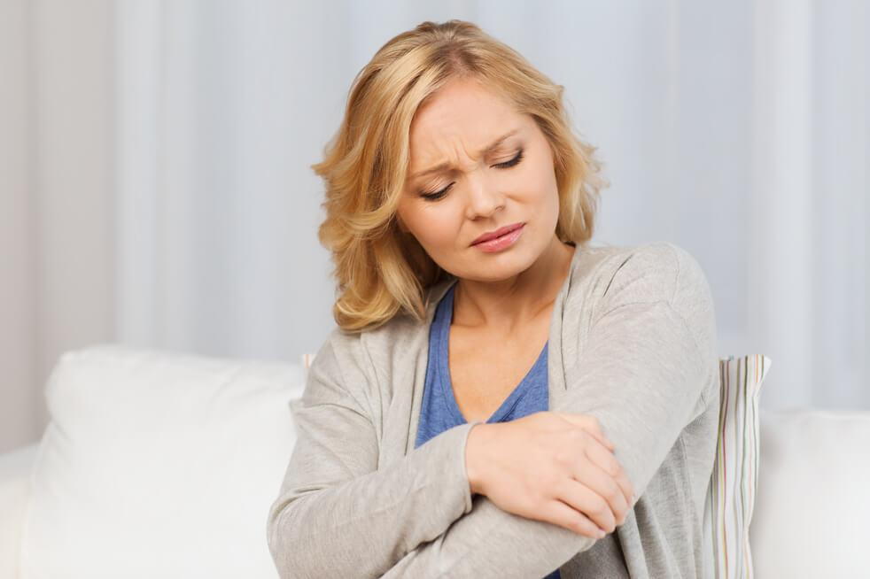 woman suffering elbow joint pain relief from chiropractor