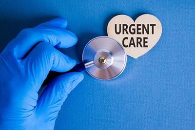 Medical professional using stethoscope on heart-shaped sign symbolizing urgent care services