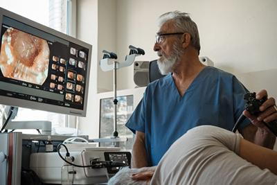 Physician using endoscope for upper GI examination