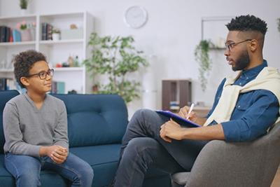 Child interacting with pediatrician for behavioral evaluation