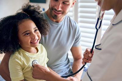 Parent and child during routine health exam with pediatrician