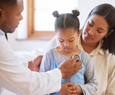 Mom holding and reassuring child at doctor's appointment