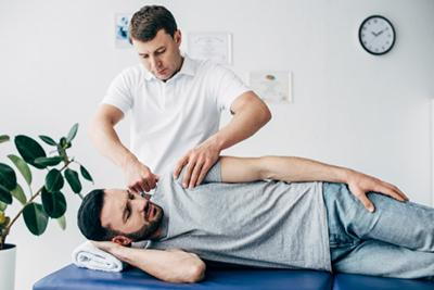 Chiropractor helping man recover from personal injury