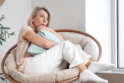 Senior woman thingking on sofa