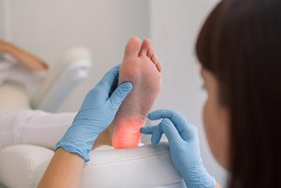 Podiatrist diagnosing cause of foot pain