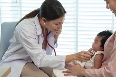 Pediatrician performing a health assessment on a newborn