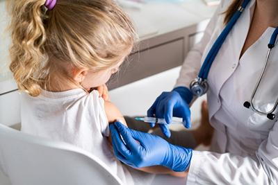 Young girl receive a vaccination from the doctor
