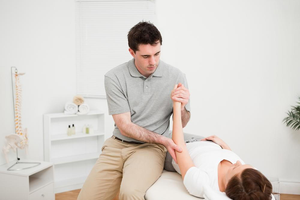chiropractor massaging patient