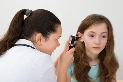 Doctor-checking-the-ear-of-young-girl-in-clinic.