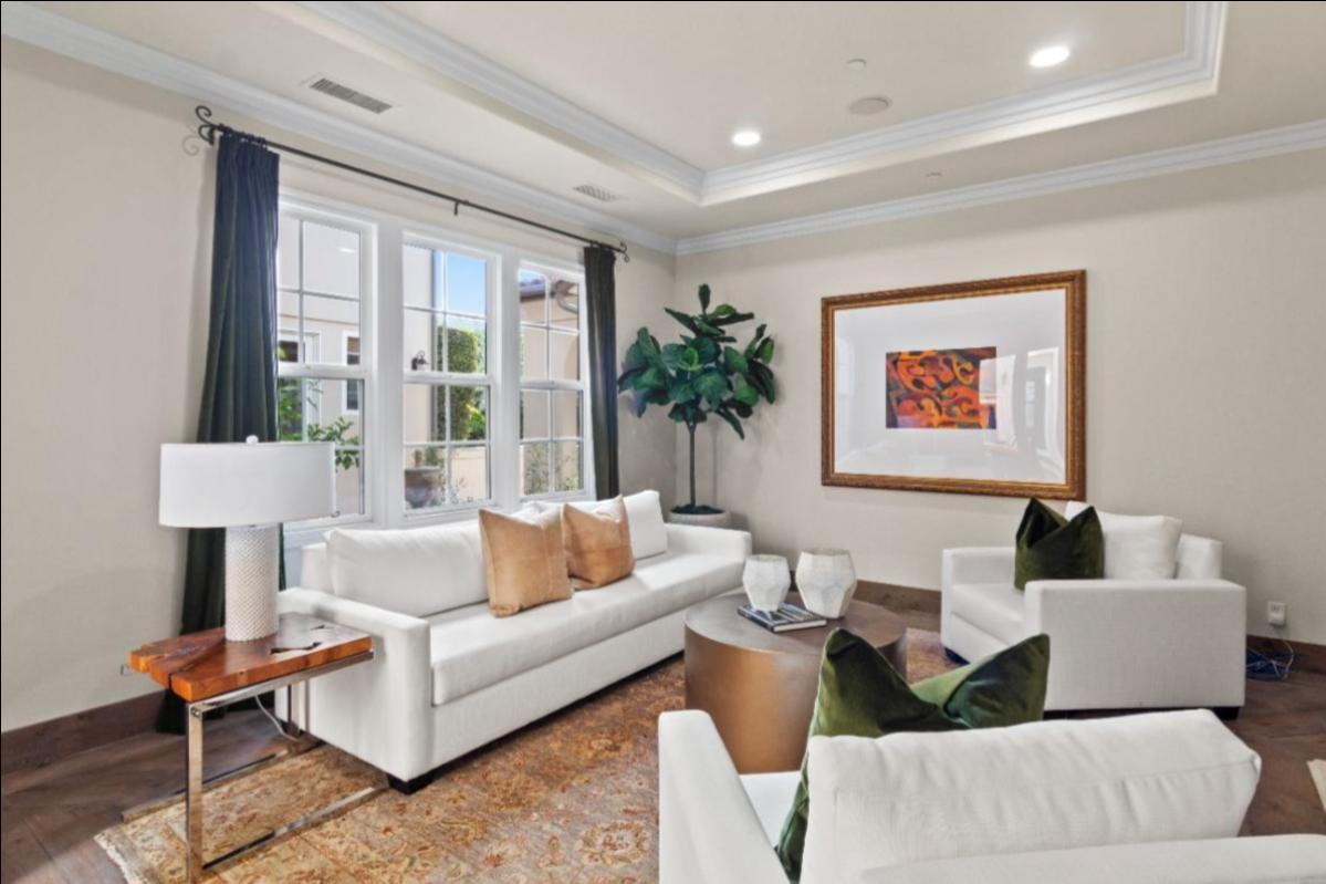 real estate photographer san diego displaying luxury real estate property living room with couch and white theme