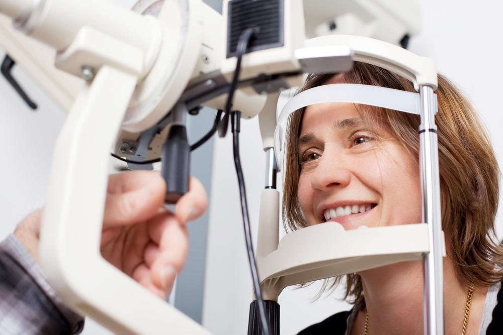 lady receiving an eye exam from her eye doctor