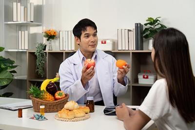 Female client receiving dietary advice from a healthcare professional.
