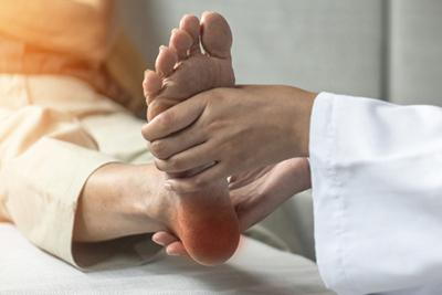 Elderly woman consulting a podiatrist for heel pain